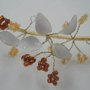 White enamel headdress with brown and orange beads