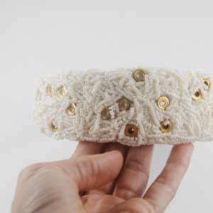 Wide quilted bridal headband with jeweled buttons.
